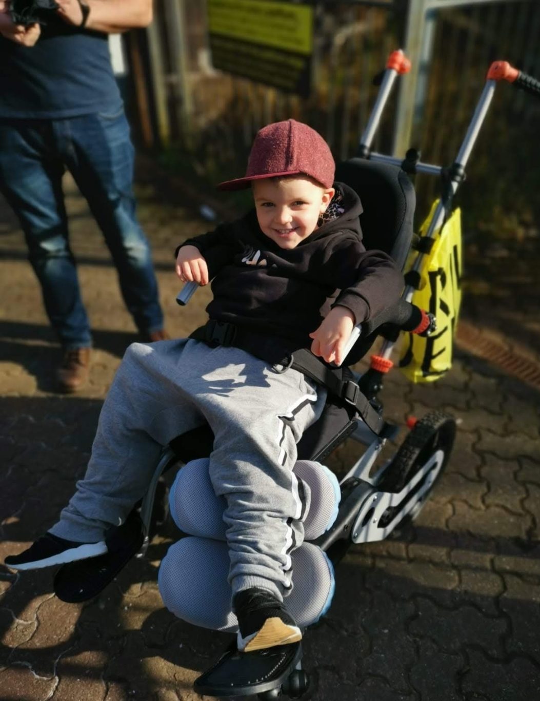 Isaac in cast and wheelchair